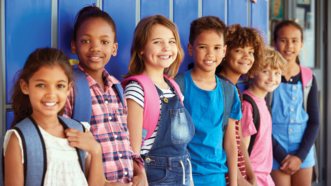 School kids in front of lockers in elementary school hallway