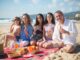 Family of 5 having a picnic at the beach, sunny day, blue sky